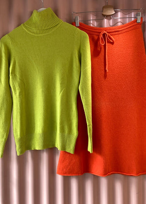 Green sweater with orange skirt