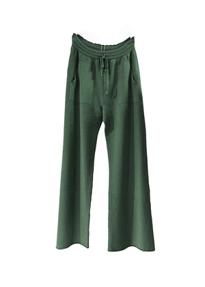 Dark olive green knit long wide pants with pockets on a white background