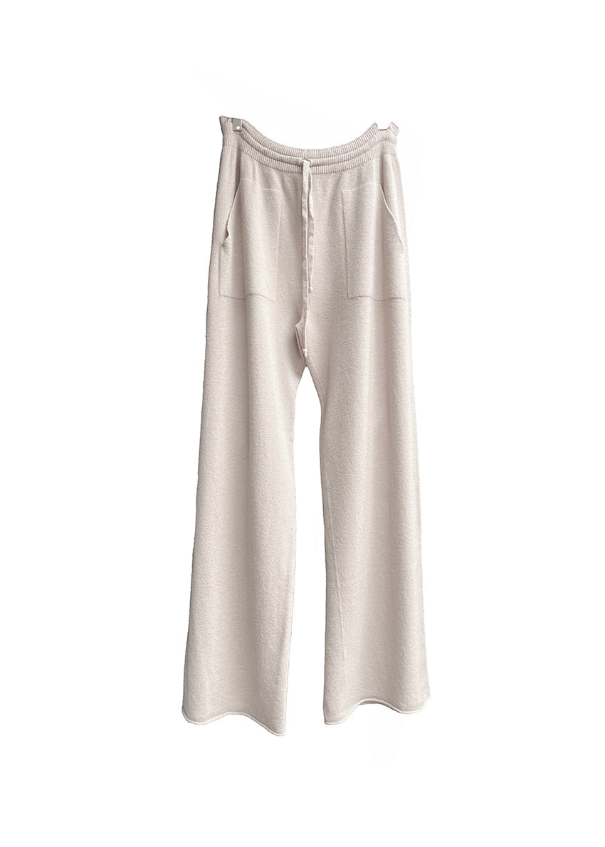 Ivory knit long wide pants with pockets on a white background