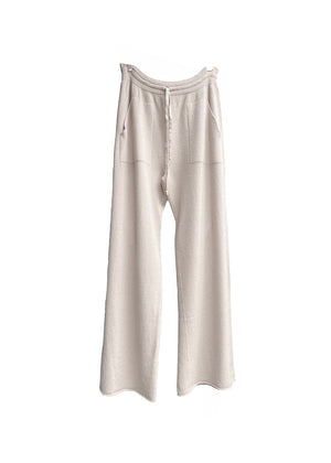 Ivory knit long wide pants with pockets on a white background