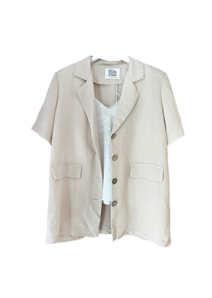 A beige short-sleeve blazer with wood-like detailing on the buttons, displayed against a white background.