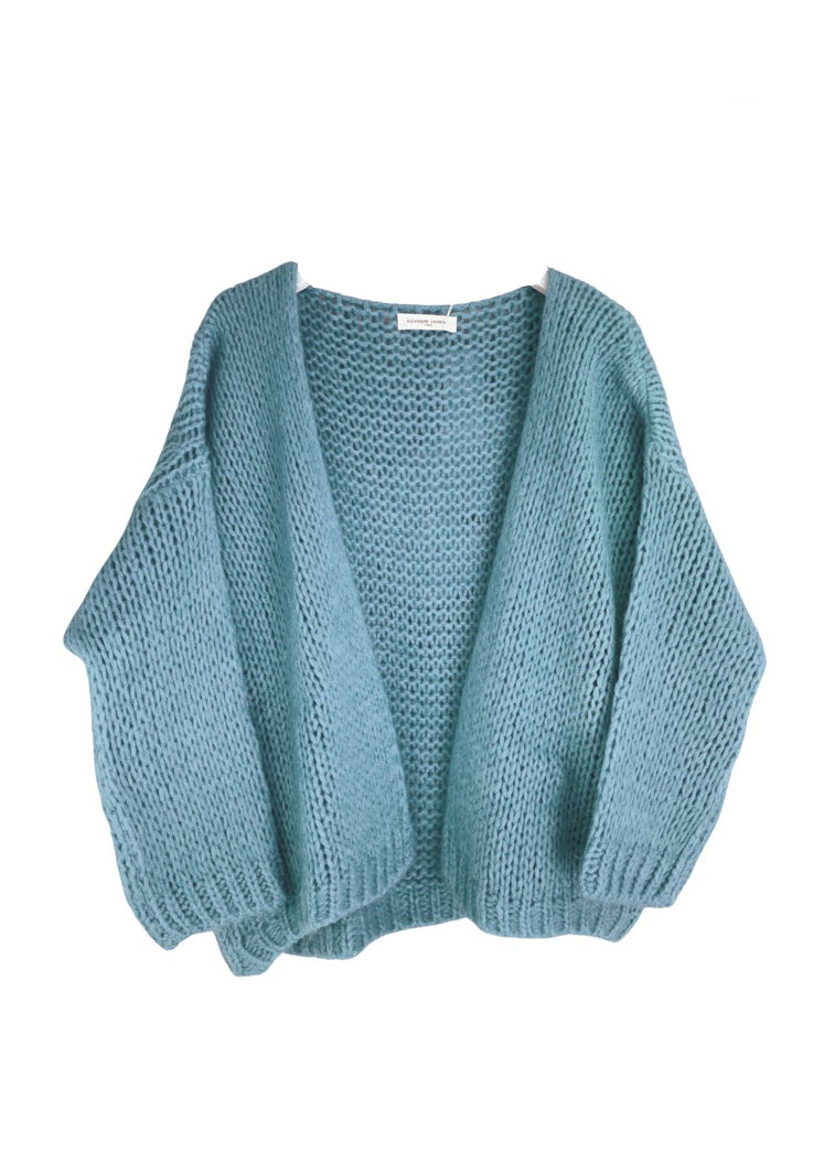 A medium sea green knit cardigan on a white background 