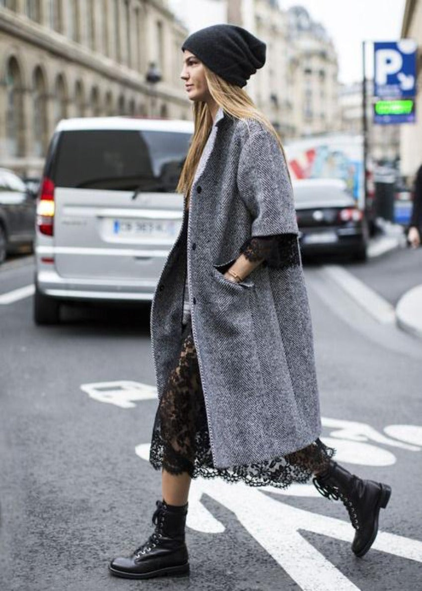 A woman wearing a black NeRo Woollen Beanie while walking on a city street
