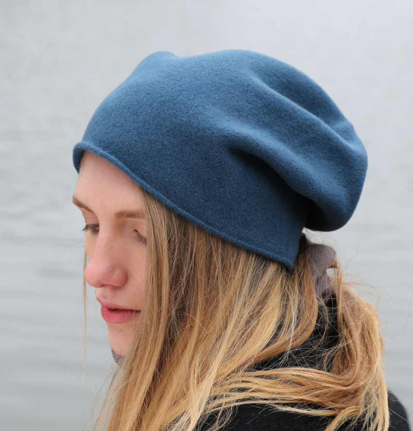 A person wearing a blue wool beanie
