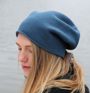A person wearing a blue wool beanie