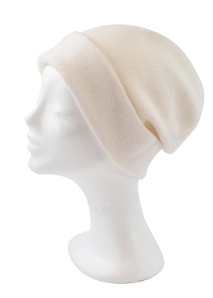 A cornsilk wool beanie on a white background 