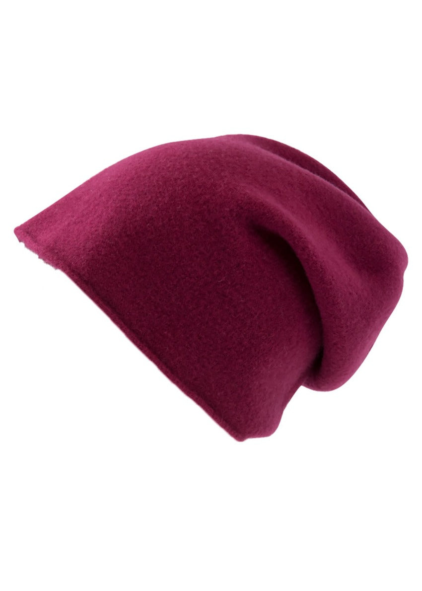 A fuchsia wool beanie on a white background 