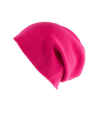 A hot pink wool beanie on a white background 