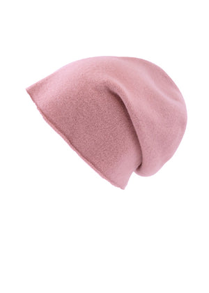 A light pink wool beanie on a white background 
