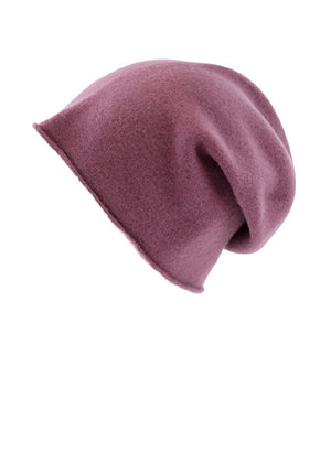 A pale violet red wool beanie on a white background 