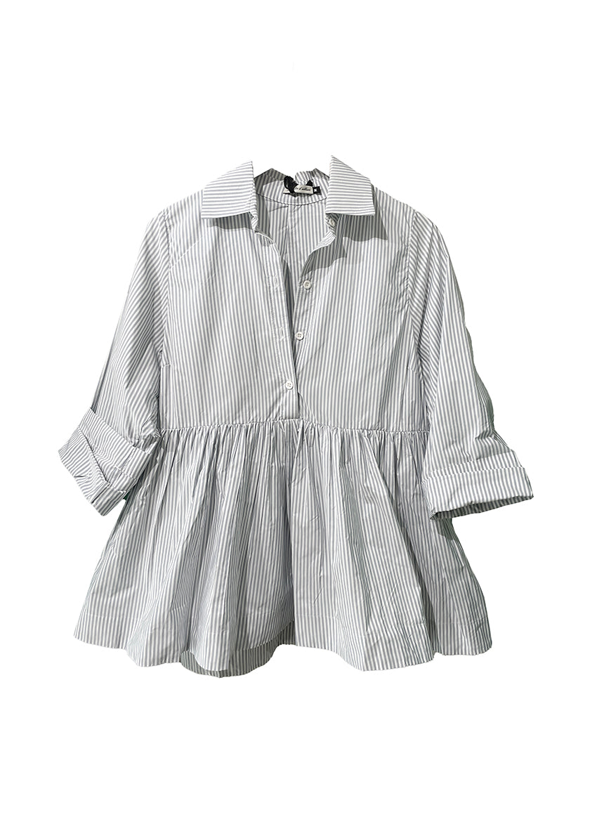 A gray striped shirt with a baby doll silhouette, three button front closure, and long, straight sleeves.