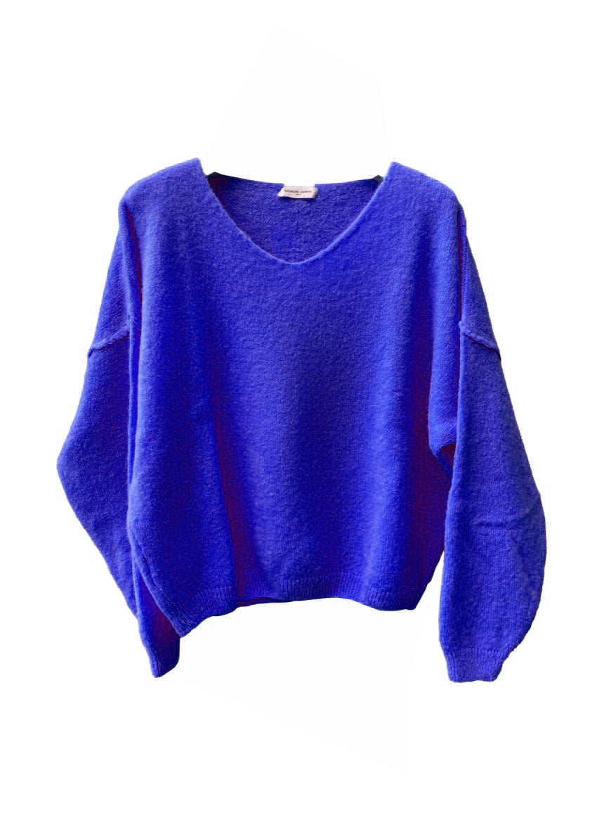 A blue, loose-fitting, long-sleeved sweater with a deep V neckline.