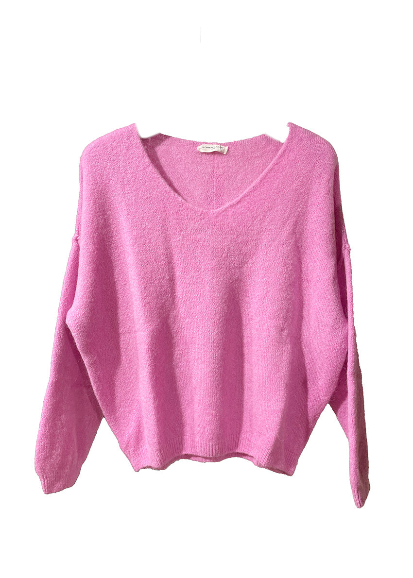 A hot pink, loose-fitting, long-sleeved sweater with a deep V neckline.