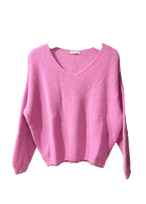 A hot pink, loose-fitting, long-sleeved sweater with a deep V neckline.