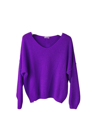 A indigo, loose-fitting, long-sleeved sweater with a deep V neckline.