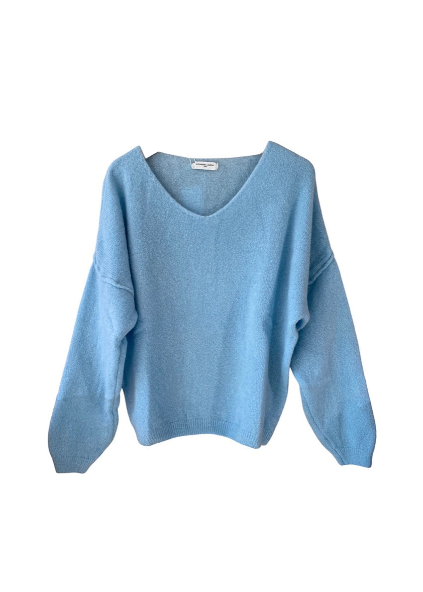A blue, loose-fitting, long-sleeved sweater with a deep V neckline.