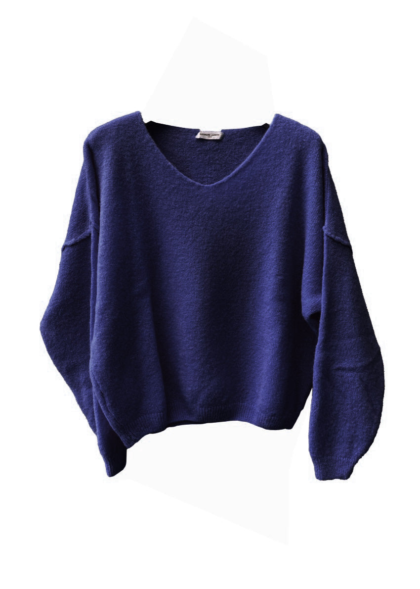 A midnight blue, loose-fitting, long-sleeved sweater with a deep V neckline.