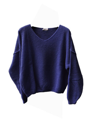 A midnight blue, loose-fitting, long-sleeved sweater with a deep V neckline.