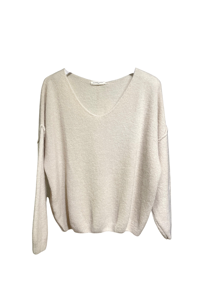A white, loose-fitting, long-sleeved sweater with a deep V neckline.