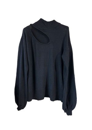 A very soft, classic black sweater, medium length, with a wide slits on the clavicle, shoulder side of the body. Made of merino wool, cashmere and other soft fibres.