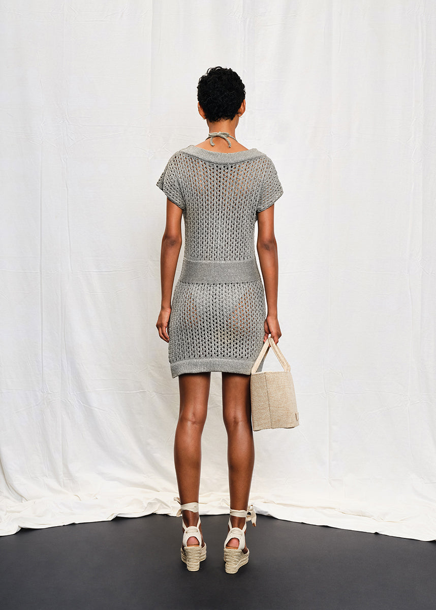 A knit mini dress with a boat neckline and short sleeves, featuring a textured silver shine on the fabric.