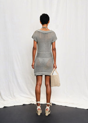 A knit mini dress with a boat neckline and short sleeves, featuring a textured silver shine on the fabric.