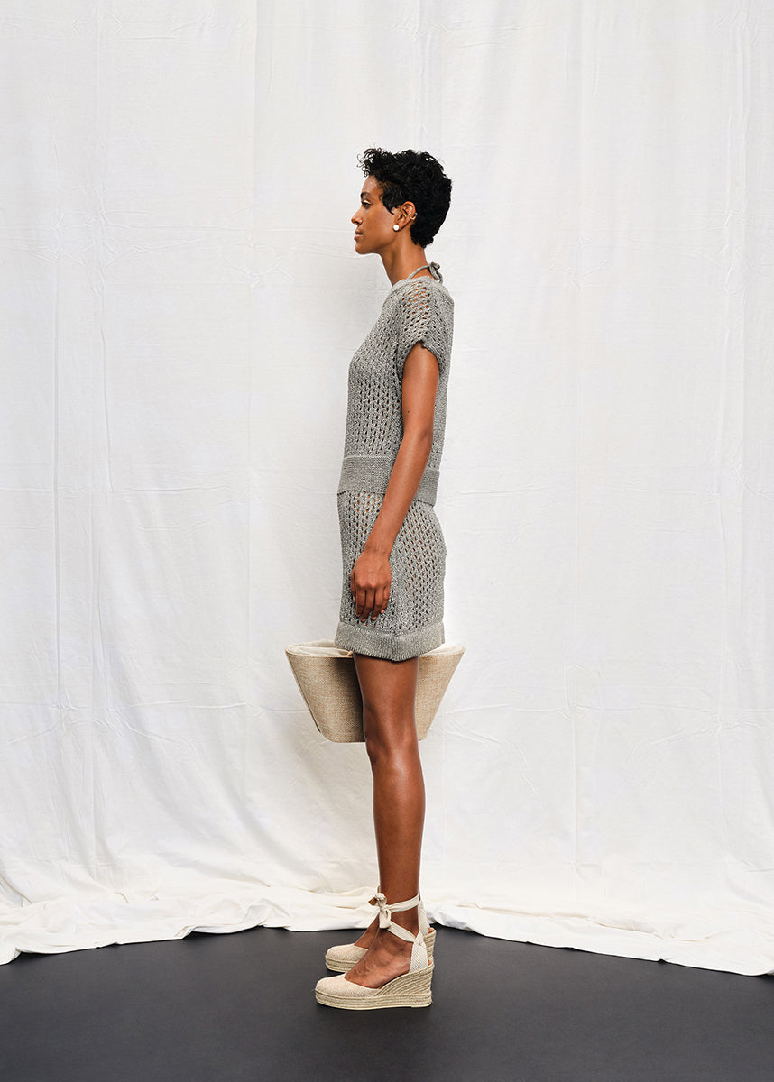 A knit mini dress with a boat neckline and short sleeves, featuring a textured silver shine on the fabric.