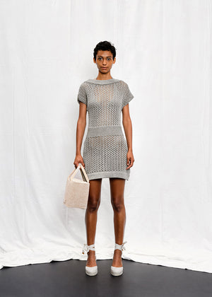 A knit mini dress with a boat neckline and short sleeves, featuring a textured silver shine on the fabric.
