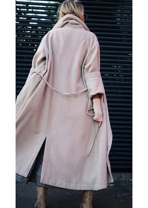Woman wearing a beige wool coat from the back 