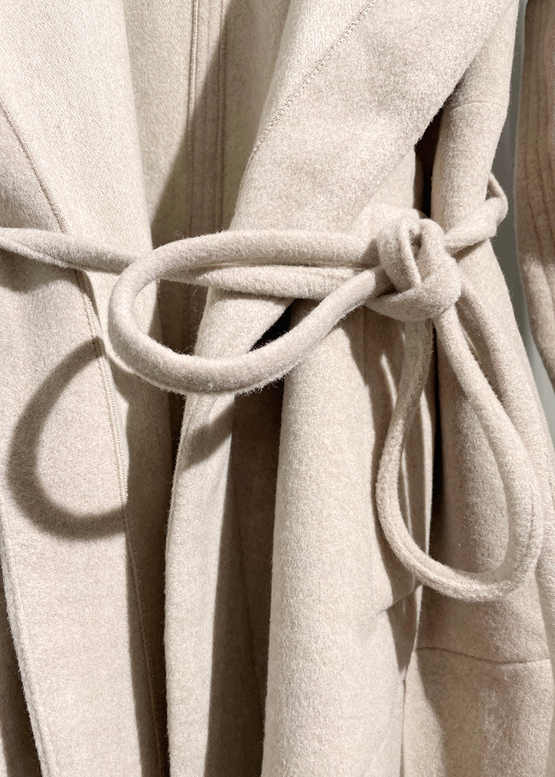 A beige wool coat close up knot