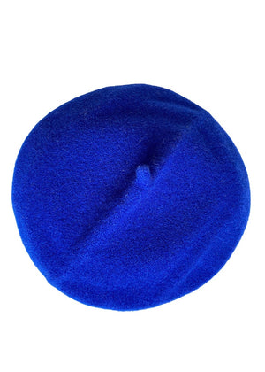 A blue wool conical beret on a white background 