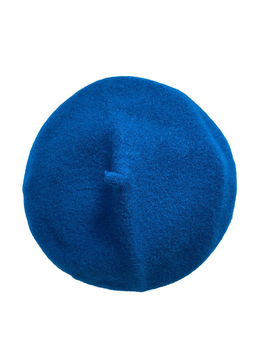 A blue wool conical beret on a white background 