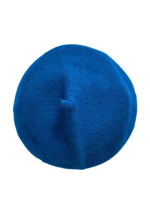 A blue wool conical beret on a white background 