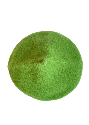 A green wool conical beret on a white background 