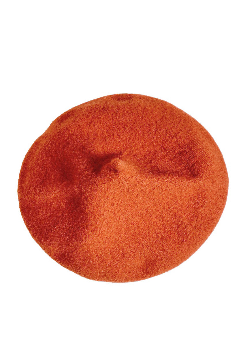 A orange wool conical beret on a white background 