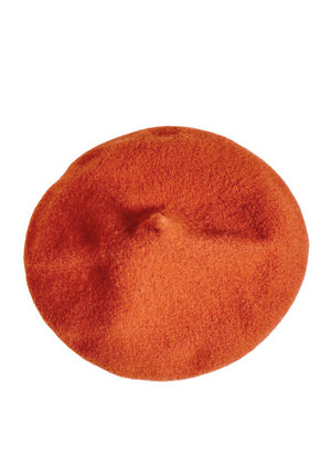 A orange wool conical beret on a white background 