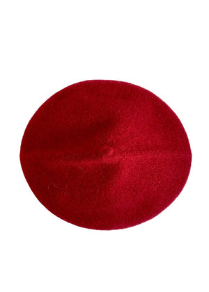 A red wool conical beret on a white background 