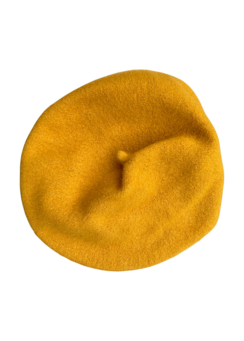A yellow wool conical beret on a white background